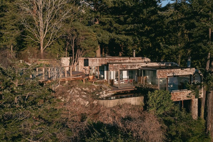 west coast home nestled and has multiple levels that cascade down a rock cliff