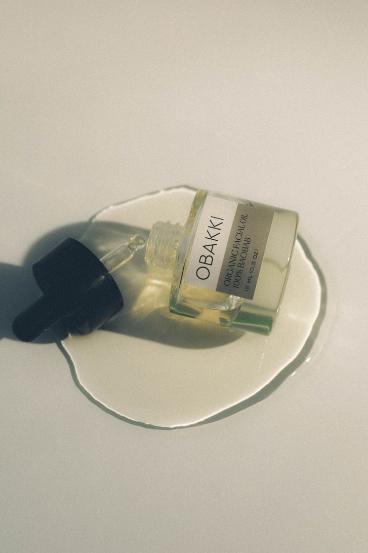 a poured out skincare product on a surface with the container named "Obakki"