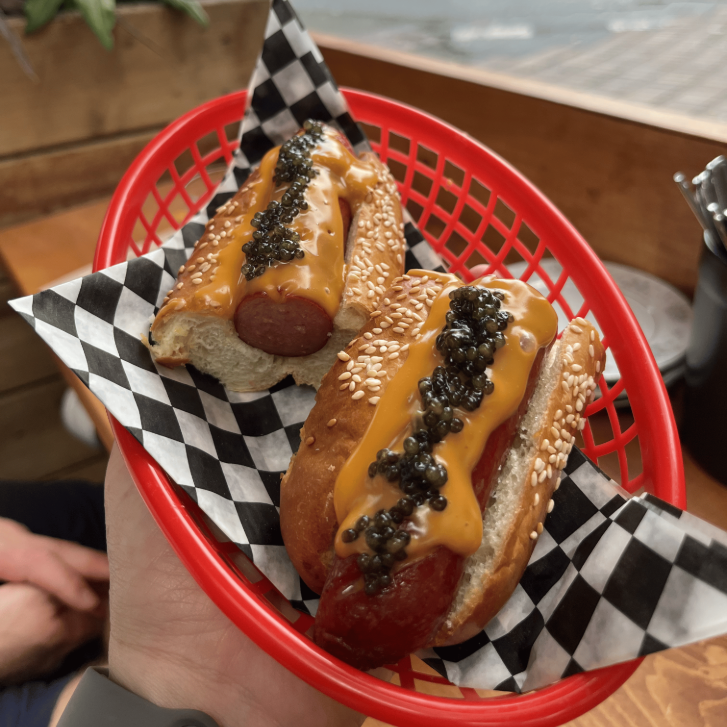 two hot dogs with cheez whizz and caviar