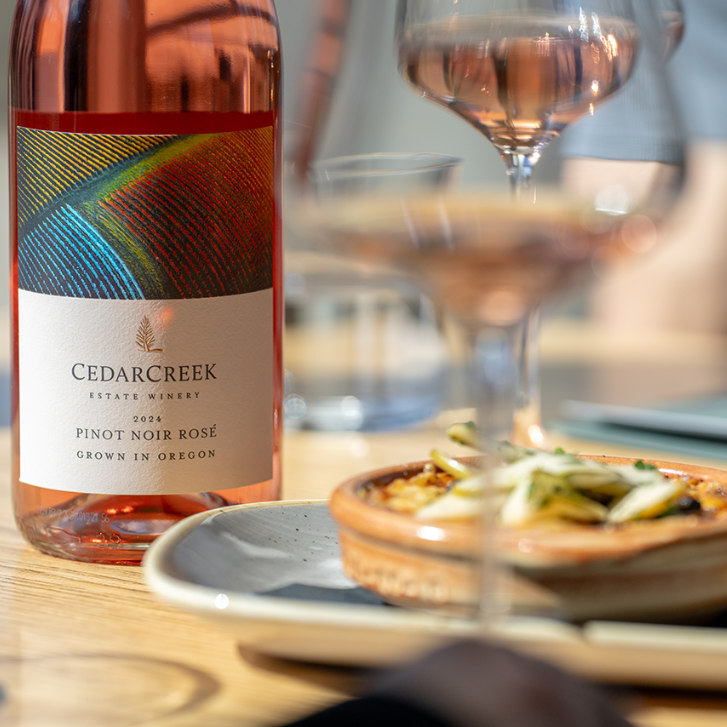 CedarCreek Estate Winery Rosé with two glasses and a plate with food