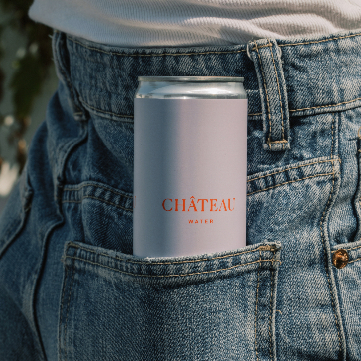 can of chateau water in the back pocket of blue jeans