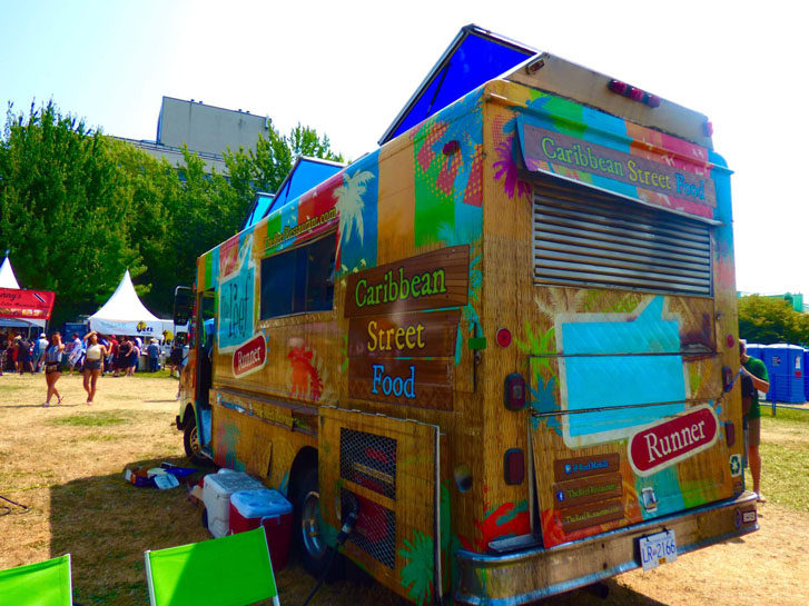 a multicolor-painted food van with the text "Caribbean Street Food"