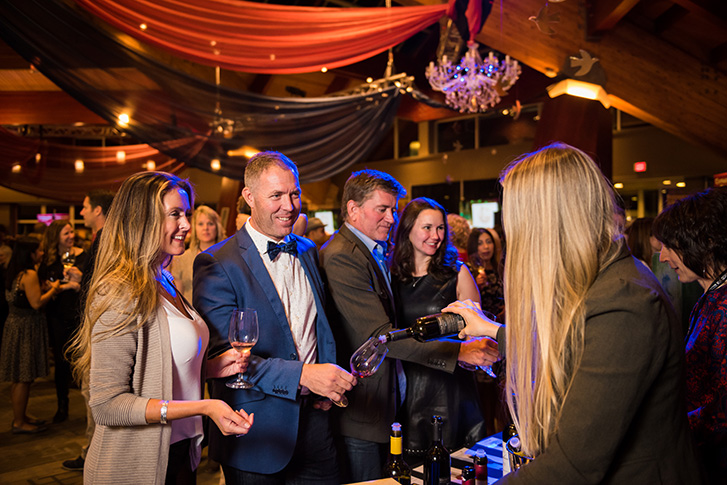 People pouring wine at the Cornucopia event in Whistler