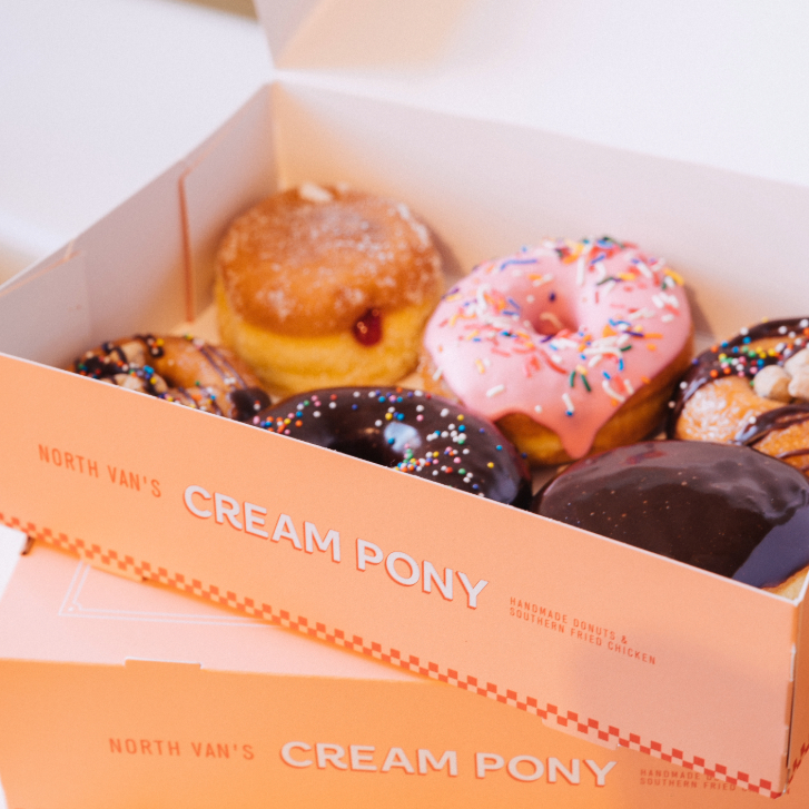 assorted donuts in a pink Cream Pony box