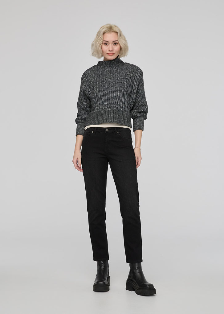 lady in black jean denim and a grey sweater by a brand