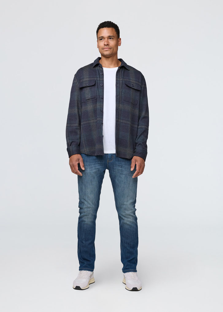 man in denim jean and a plaid long-sleeve shirt