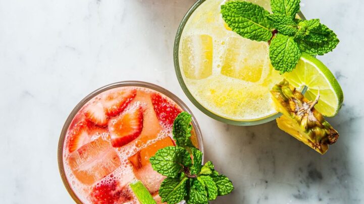 a yellow and red summer mocktails in glass cups