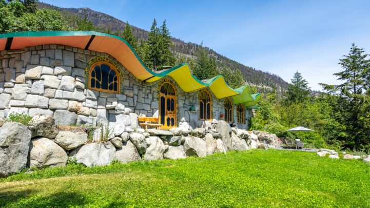 an ‘Earthship’ dream home, an undulating roof with a vibrant green and orange glaze with the inner and outer wall of the property made of exposed stone