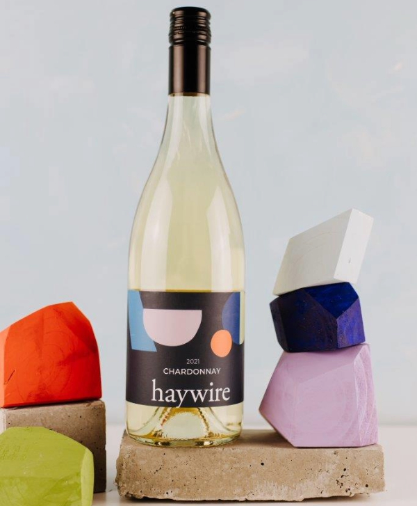 haywire chardonnay on white display with colourful stones