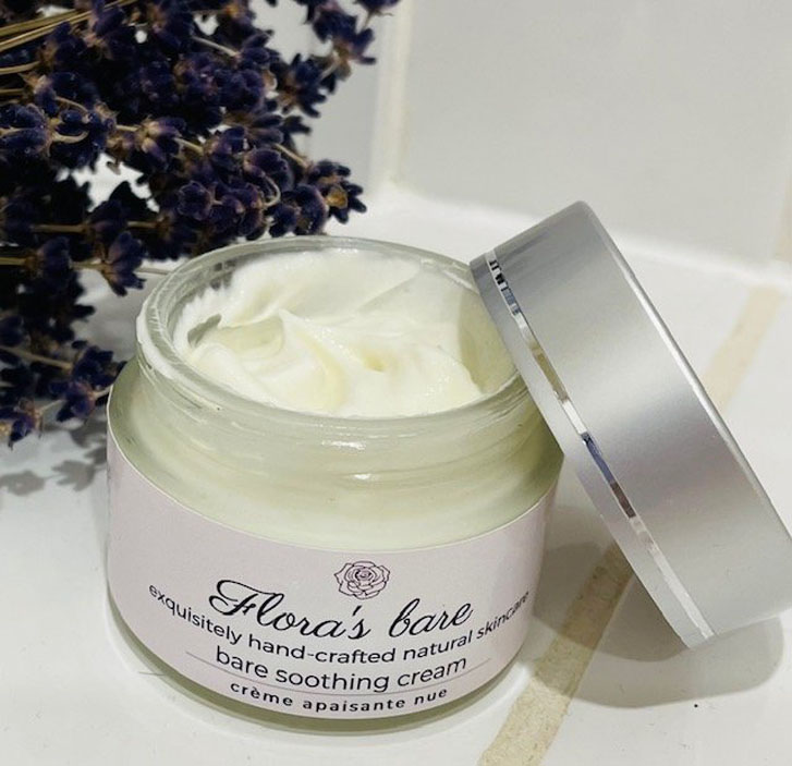 an open skincare cream product titled "Flora’s Bare "