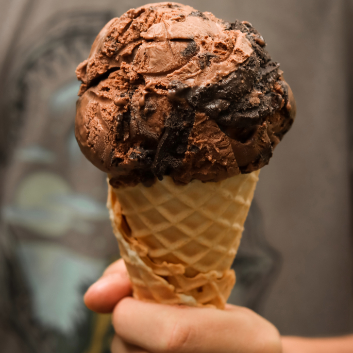 person holding chocolate ice cream cone from Chocolate Tofino