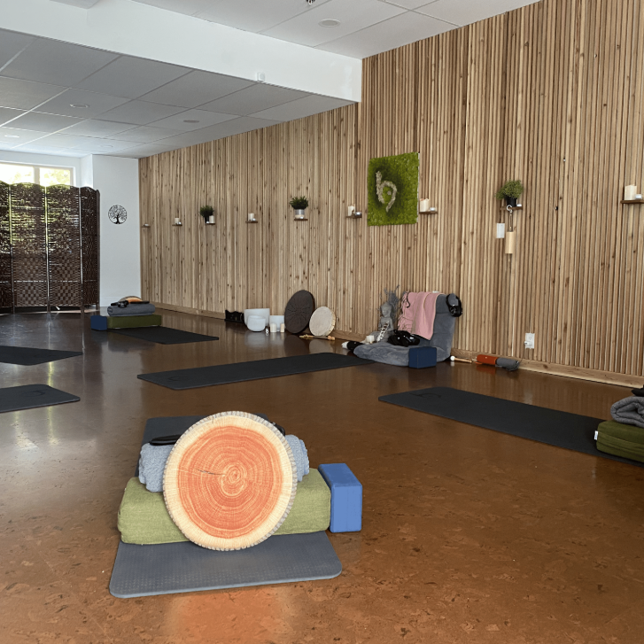 empty studio with mats, blocks and blankets arranged at BreathWorks Studio