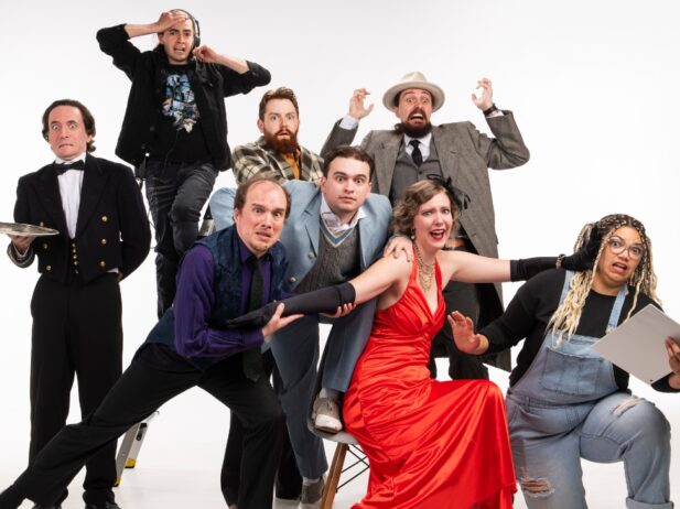 a group of dressed theatre performers making faces and stances