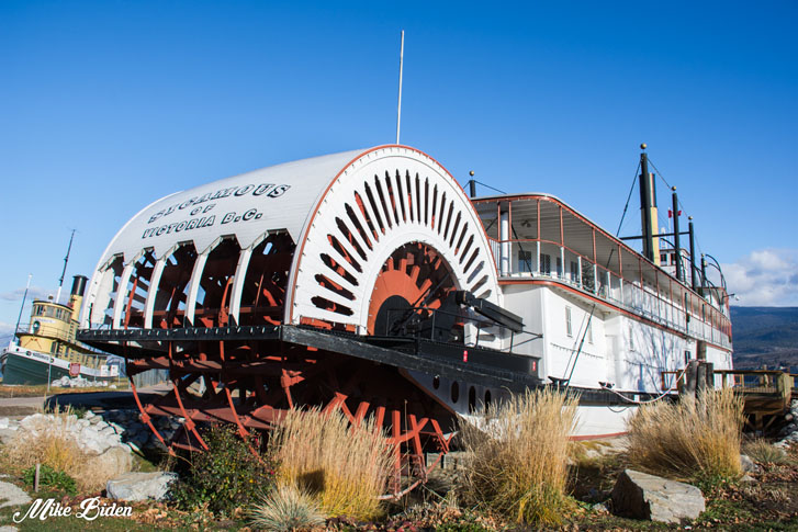 a ship ashore on land with the sea just behind it