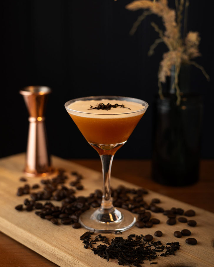 a brownish cocktail on a wooden surface