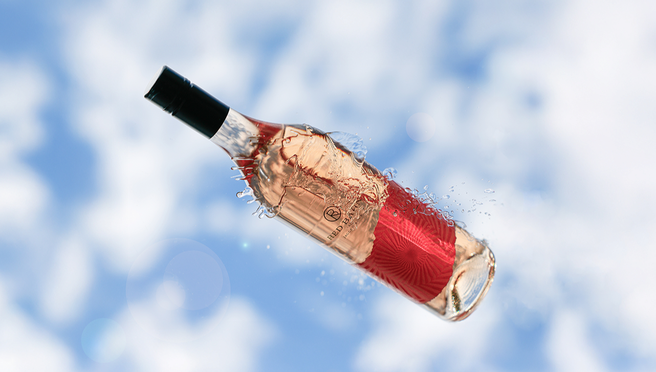 bottle of Red Barn Rosé in the sky