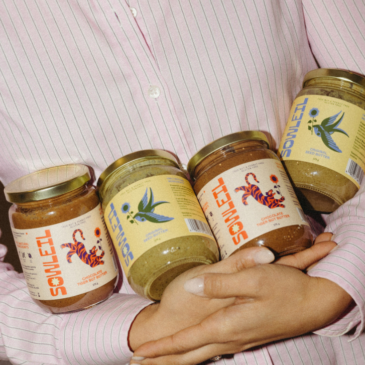 Person in a pink shirt holding Sowleil Nut-free seed butter