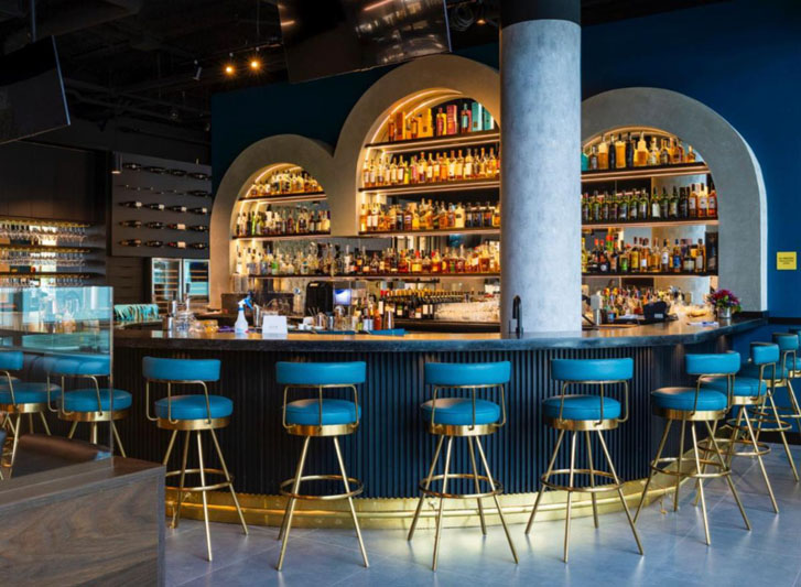 a food restaurant with chairs around a bar counter