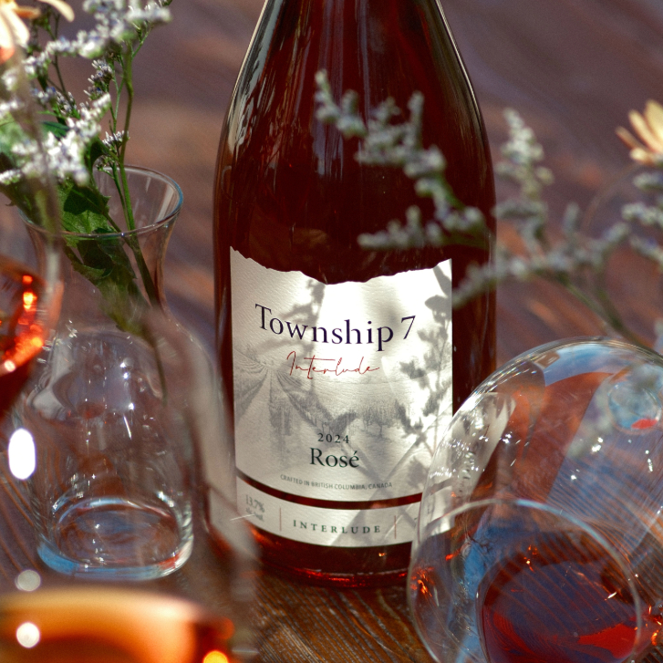 bottle of Township 7 Interlude Rosé with two wine glasses