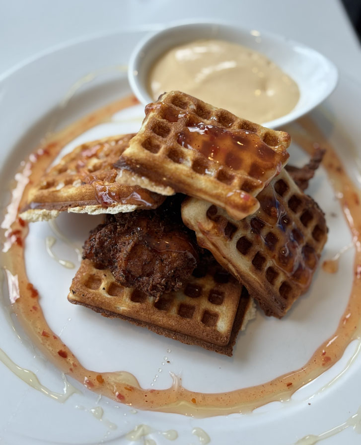 sunshine coast chicken won benny: Southern-fried chicken heaped upon waffles and topped with both hollandaise sauce and maple syrup.