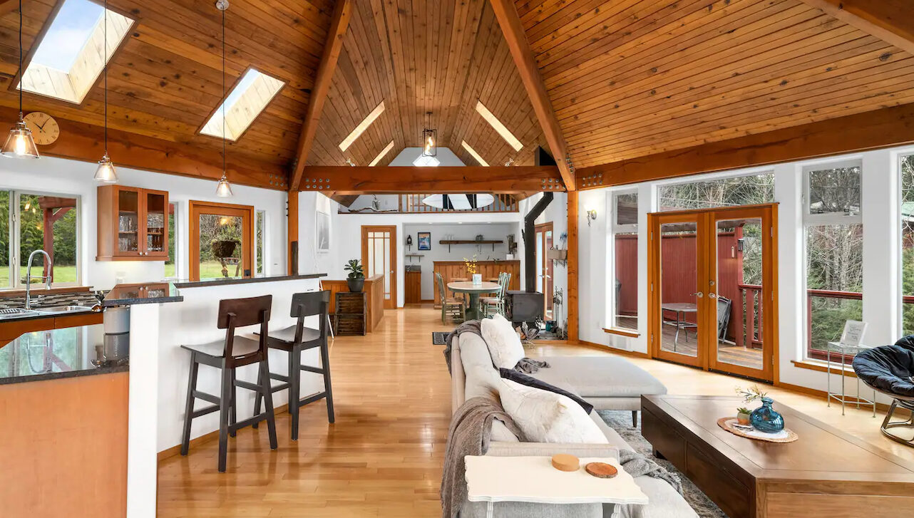 interior of cedar island coastal home with a dining, living room space and kitchen space