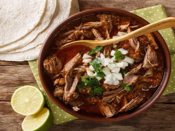 beef stew in bowl and white taco wraps on the table