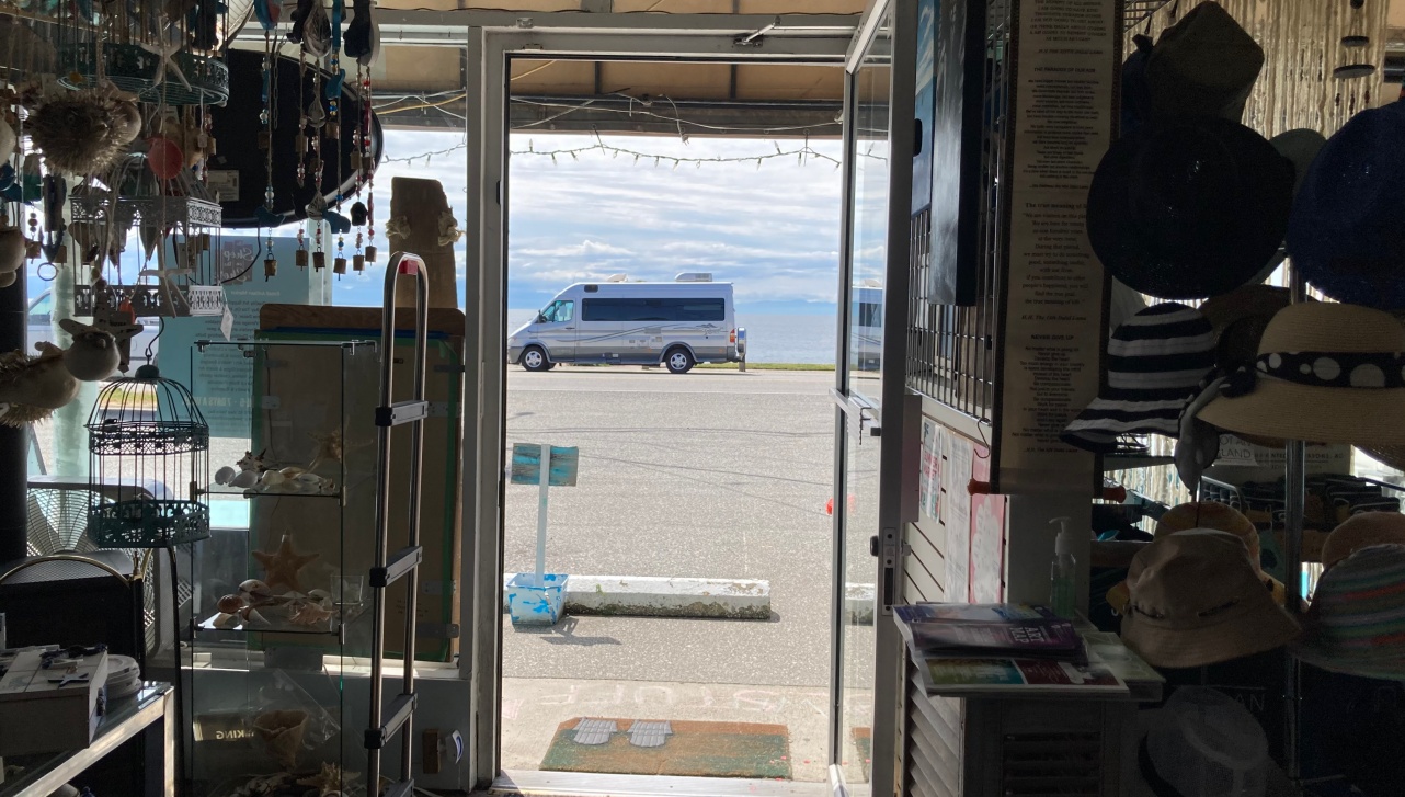 car driving past an open shop on the other side while visit in BC