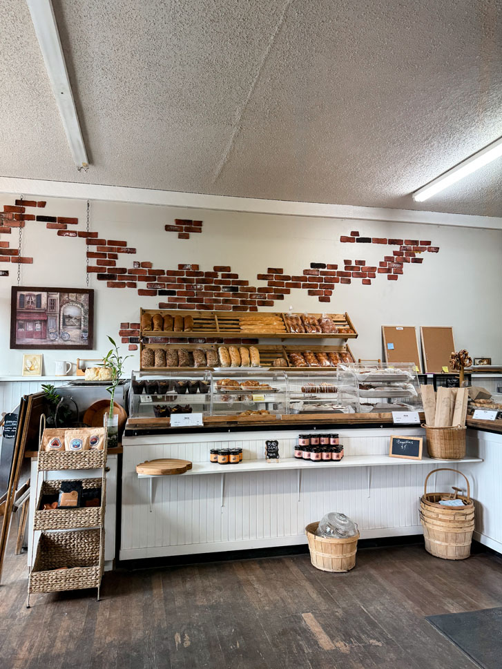 a shoppe with mouth watering deserts on shelves and at the counter