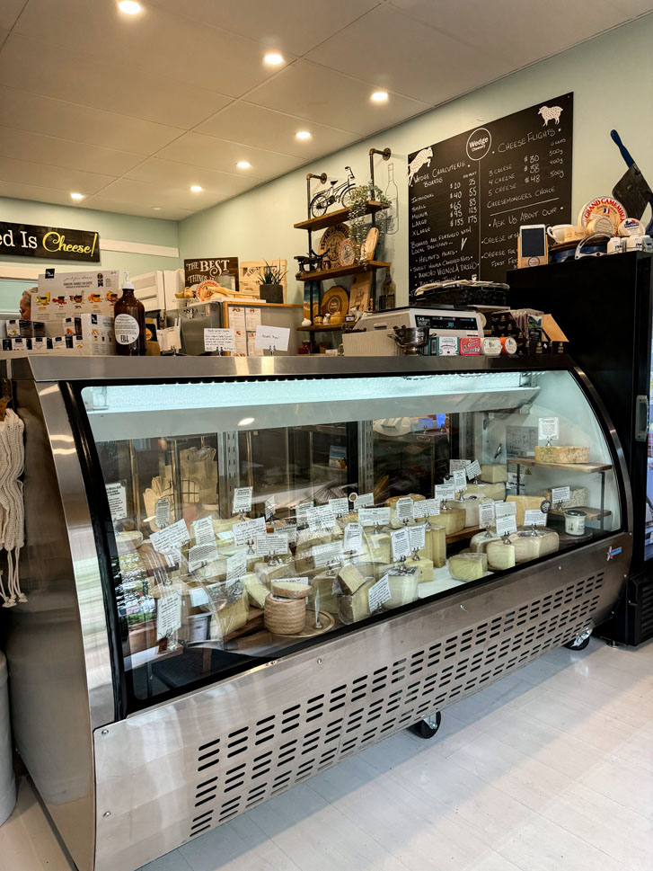 a variety of cheese in a huge showcase