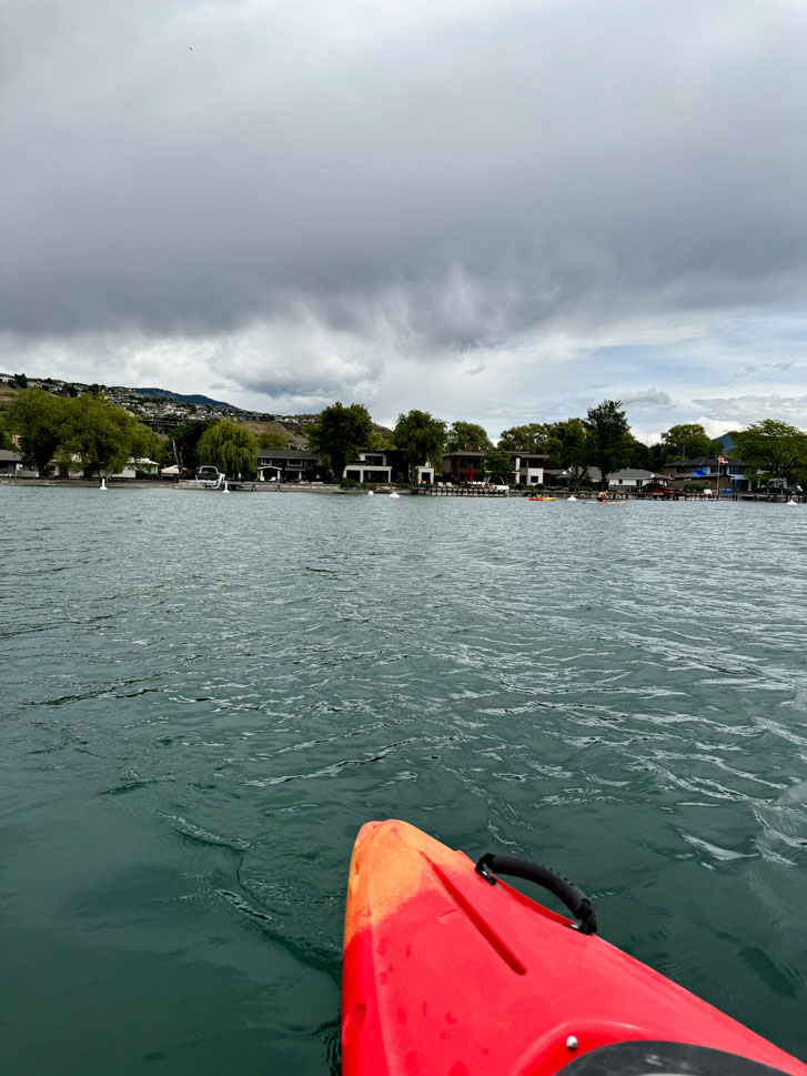 the edge of a paddle board in an aerial view of a lake