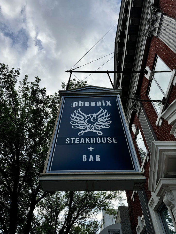 'Phoenix Stakehouse + Bar' sign outside of a building