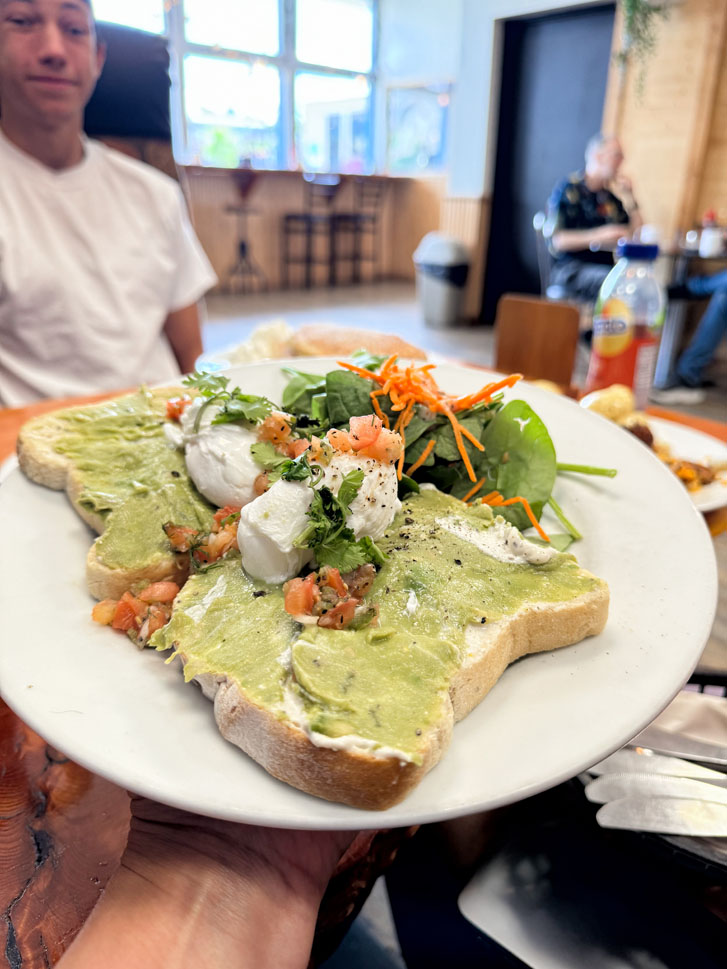 bread slices spread with avocado and veggies beside bread slices