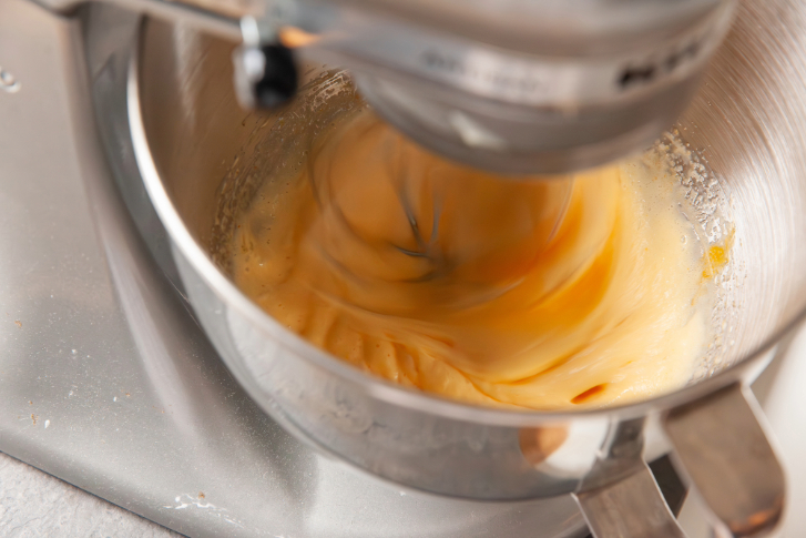 close up on mixer beating eggs and sugar
