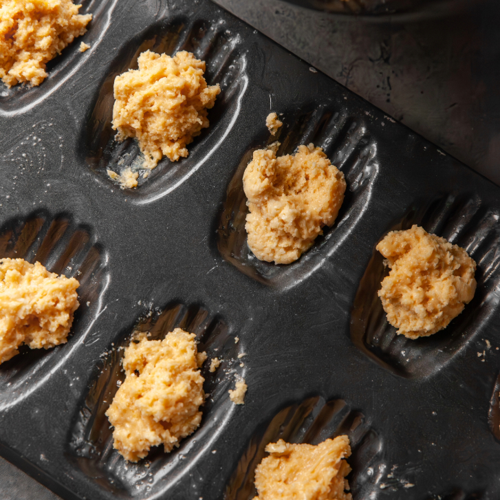 madeleine dough in baking pan