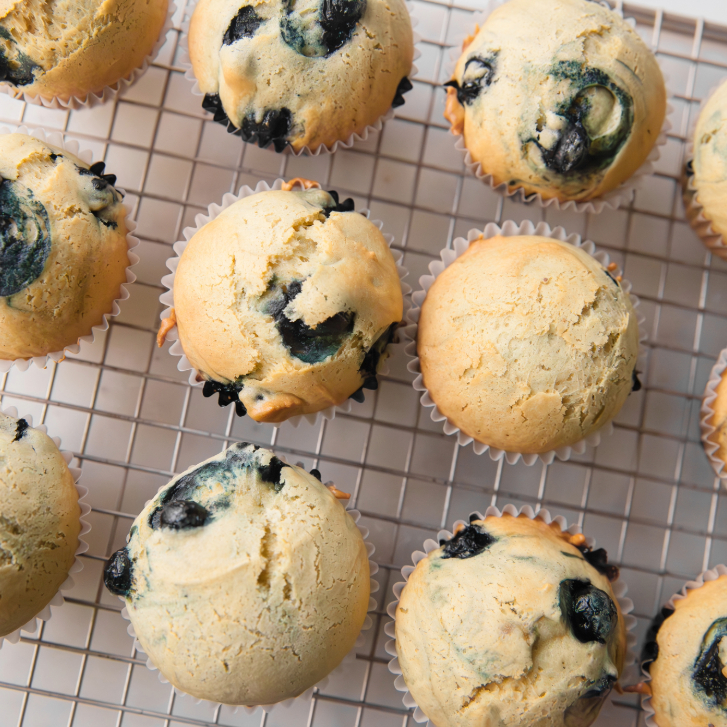 blueberry muffins on a metal drying rack