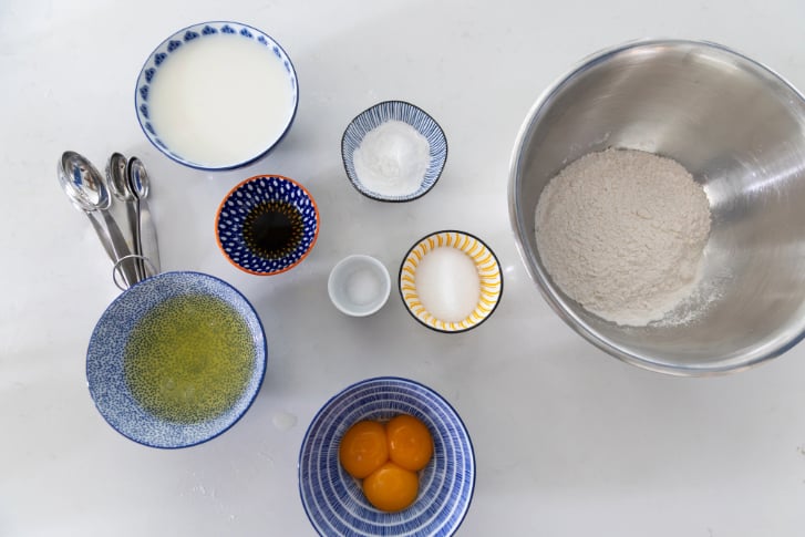 ingredients in bowls on a white counter for a waffles from scratch recipe