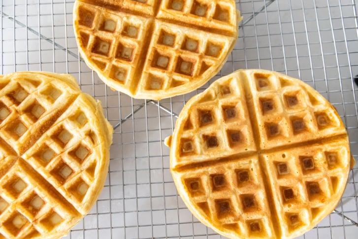 three round waffles on a cooling rack 