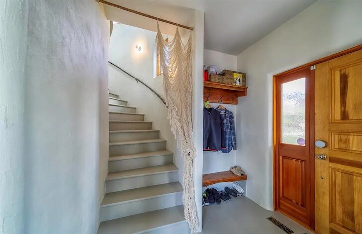 a stairway with a wooden door at the end