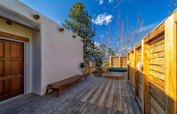 an outdoor sitting area at the back of the house